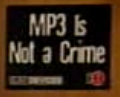 black sign with white text reading 'MP3 is not a crime'